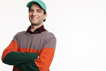 Young happy man in cap smiling and looking at camera
