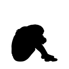 Silhouette of woman sitting hugging her knees