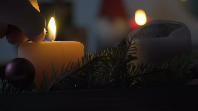 Lighting a candle from Christmas decoration in a living room, 4k, Stock Footage
