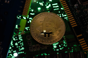 In this photo illustration, Bitcoin cryptocurrency commemorative coins on circuit board.