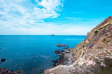 Fototapeta na wymiar Rocks in the blue sea of Eo Gio cape, Binh Dinh province, Vietnam.