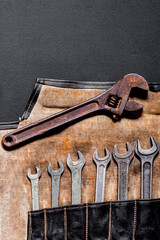 A set of old metal tools for repairs and business in a black case