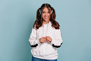 Smiling pretty girl with dark wavy hair enjoying the positive news, looking at the camera with a...