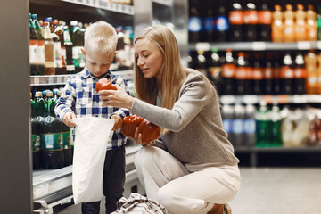 Family buying groceries. Mother in gray sweater.