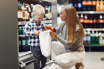 Family buying groceries. Mother in gray sweater.