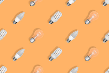 Lighting lamps seamless pattern. Background on the theme of light bulbs.