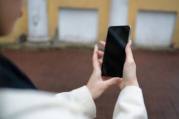 phone in the hands of a girl on the street mockup