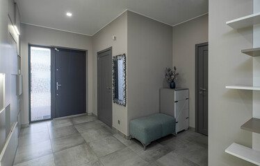 Modern interior of entrance hall in luxury apartment. Grey colors. Home design.