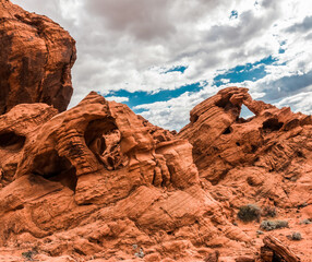 Fototapeta na wymiar The Triple Arch With The Muddy Mountains in The Distance, Valley of Fire State Park, Nevada, USA