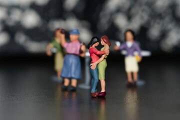 group of miniature gay figures with in the middle a female couple dancing