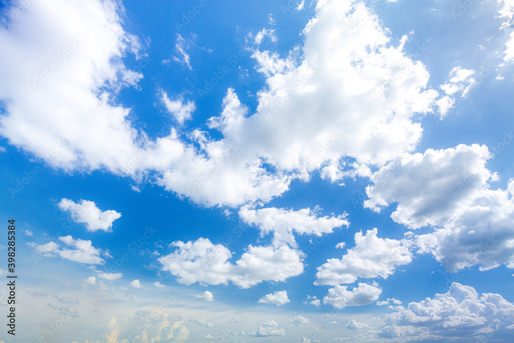 Wall mural white cumulus clouds in blue sky at daytime. natural background photo texture