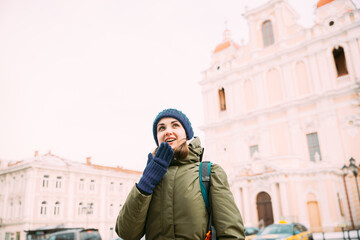 Vilnius, Lithuania. Young Beautiful Pretty Caucasian Girl Woman Tourist Smiling On Background Church Of St. Casimir