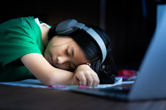 ASMR sound for relax.tired teenager asian girl sleep with headphones.Sleep and listen podcast asmr for good sleep and relax.Lifestyle at home.Online learning.Education, People, music sensation sound.