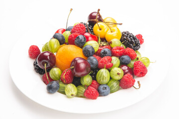 Assorted fresh different berries on a white plate. useful vitamin healthy food fruit. healthy vegetable breakfast