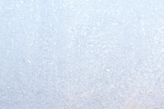Graceful expressive winter natural background, macro texture. Copy space. Frosty pattern on winter window glass