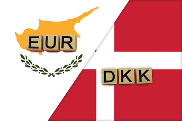 Fototapeta na wymiar Cyprus and Denmark currencies codes on national flags background