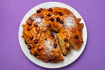 typical portuguese fruit cake Bolo rainha on white dish