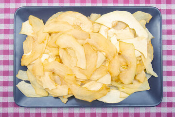 slices of dried melon on a plate. fruits and vitamins. Healthy food.