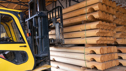 The loader transports round logs at the sawmill.