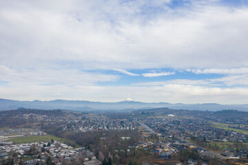 Peaceful town surrounded by trees with mountains as background