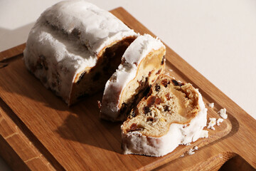 Food - a beautiful birthday cake on a wooden board. The background is white.