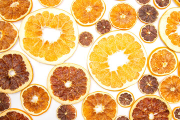 mix of different pieces of dried citrus fruit on white background