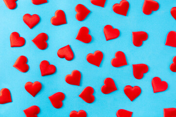 Red hearts pattern background on blue background. Top view. Valentines day concept