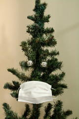 Christmas tree with face mask. Christmas decoration. Coronavirus pandemic Covit-19.