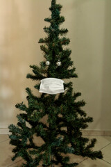 Christmas tree with face mask. Christmas decoration. Coronavirus pandemic Covit-19.