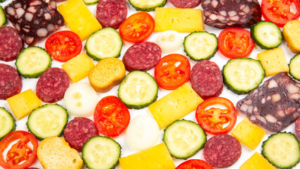 sliced ​​pieces of sausage, salami, cheese, cucumber and tomato. fast food. ingredients for pizza. calories and diet