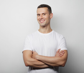 lifestyle and people concept: Portrait of a smart young man wearing casual standing over white background