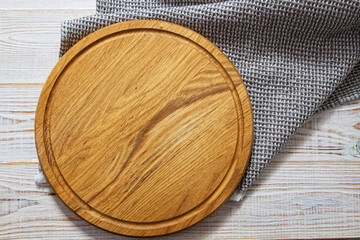 Wooden board mock up and grey napkin top view on wooden table