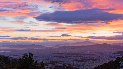 Aerial view of Athens from Hymettus mountain during sunset. In the background the port of Pireaus.