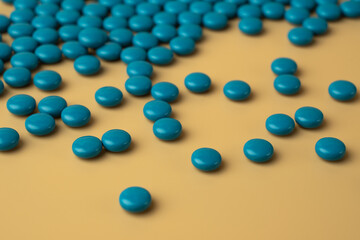 blue pills on beige color background