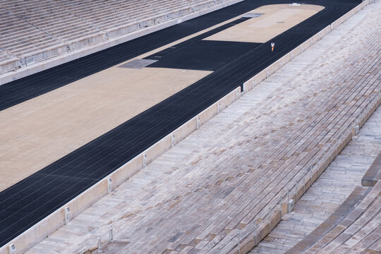 Single person runs in the Kallimarmaro stadium, built fully of marble, which hosted the first modern Olympic games