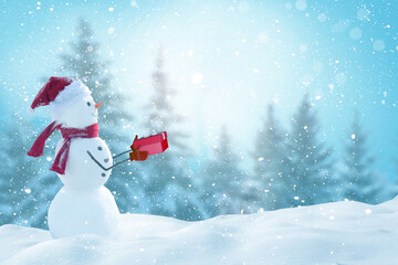 Cute smiling snowman holding red gift box .Winter fairytale.Merry christmas and happy new year...