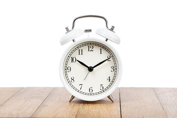 Retro alarm clock on wooden table . Old fashioned alarm clock