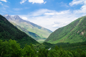 Fototapeta na wymiar A mountain valley opens up between the Caucasus mountains