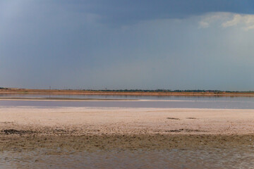 Dark storm clouds over a salt lake before a rain