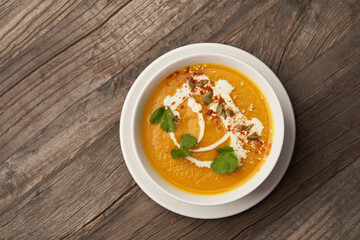 Pumpkin soup on a wooden table. Pumpkin soup puree