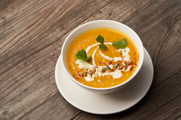 Pumpkin soup on a wooden table. Pumpkin soup puree