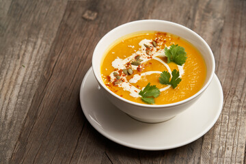 Pumpkin soup on a wooden table. Pumpkin soup puree