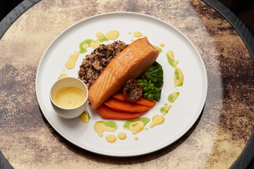 Salmon fillet and rice on white plate. Baked salmon with rice