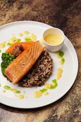 Salmon fillet and rice on white plate. Baked salmon with rice