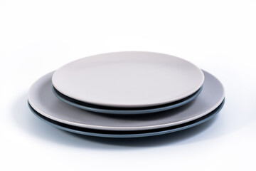 Stack of Dish Sets - Navy Blue and Grey plates isolated on white background side view, selective focus