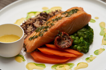 Salmon fillet and rice on white plate. Baked salmon with rice