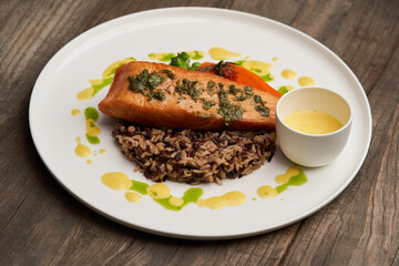 Salmon fillet and rice on white plate. Baked salmon with rice