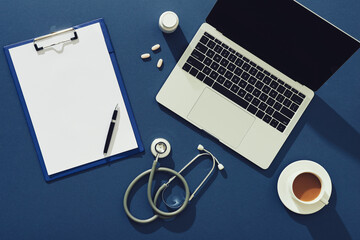 Doctors desktop with stethoscope and medical supplies