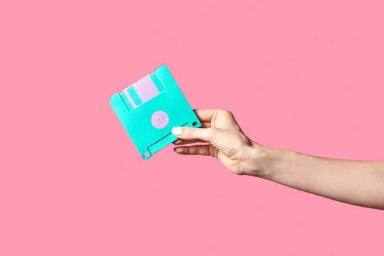 Handmade paper floppy disk in a hand.