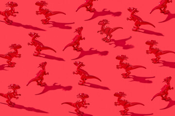 Toys of plastic dinosaurs with shadows.